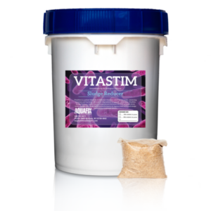 A bucket of VitaStim Sludge Reducer, a powdered product of temperature specific bacteria, designed to reduce organic material retained in sludge.